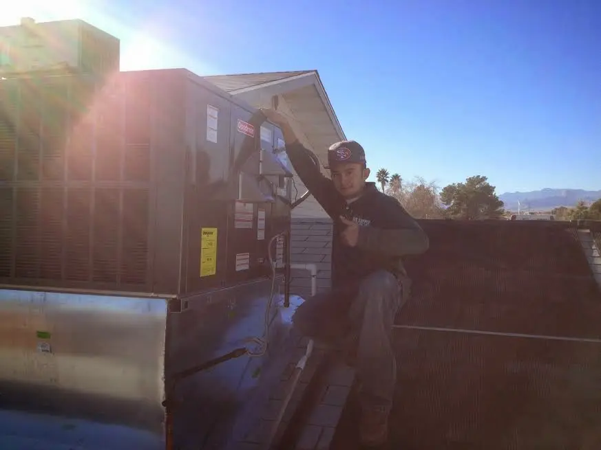 HVAC technician performing HVAC Inspection on a rooftop unit in East Earl